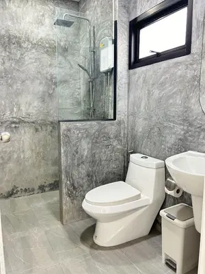 a bathroom with a toilet and a sink and a shower at JK Studio, Koh Yao Noi in Ko Yao Noi