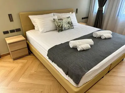 a bedroom with a bed with two pillows on it at Naka Central Happy Home in Phuket city in Ban Rangeng