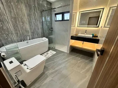 a bathroom with a toilet and a tub and a sink at Naka Central Happy Home in Phuket city in Ban Rangeng