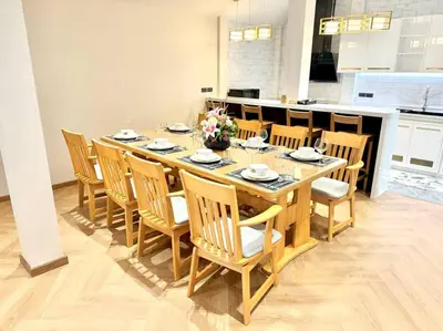 a dining room with a table and some chairs at Naka Central Happy Home in Phuket city in Ban Rangeng