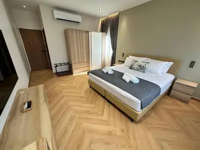a bedroom with a bed with two towels on it at Naka Central Happy Home in Phuket city in Ban Rangeng