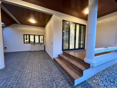 an empty room with a staircase in a house at Naka Central Happy Home in Phuket city in Ban Rangeng