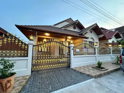 a house with a gate and a fence at Naka Central Happy Home in Phuket city in Ban Rangeng