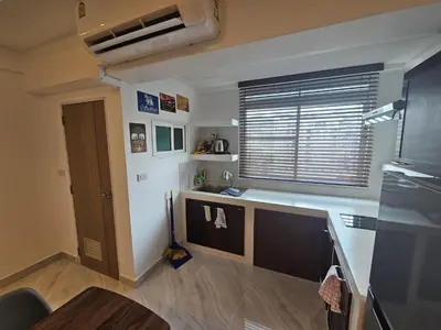 a small kitchen with a counter and a window at Yuya's sweet Condo suite in Patong Beach