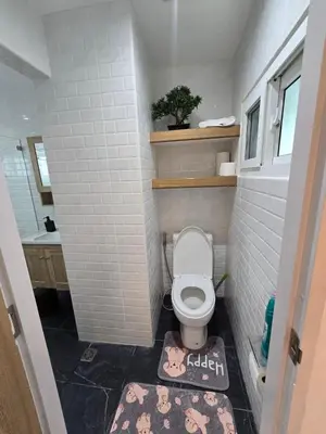 a small bathroom with a toilet and a sink at Yuya's sweet Condo suite in Patong Beach