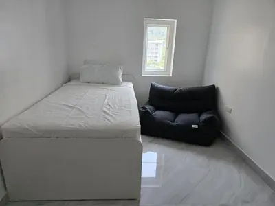 a bedroom with a bed and a couch in it at Yuya's sweet Condo suite in Patong Beach