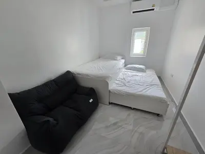 a small room with a bed and a couch at Yuya's sweet Condo suite in Patong Beach