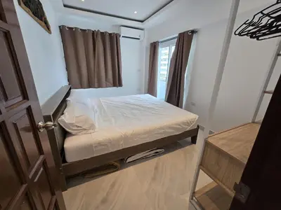 a small bedroom with a bed and a window at Yuya's sweet Condo suite in Patong Beach