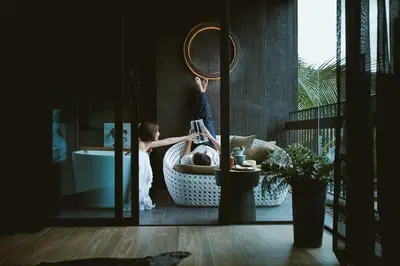 a child standing in a bathroom with a mirror at Luxury Suite of 70 Sqm in Rawai Beach in Ban Saiyuan (1)