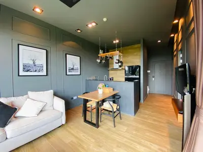 a living room with a couch and a table at Luxury Suite of 70 Sqm in Rawai Beach in Ban Saiyuan (1)