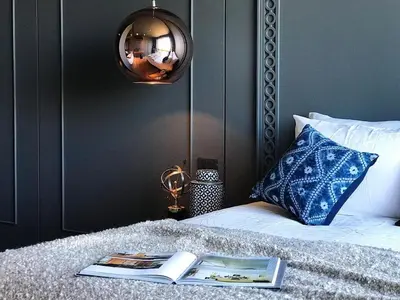 a bedroom with a bed with a book and a lamp at Luxury Suite of 70 Sqm in Rawai Beach in Ban Saiyuan (1)