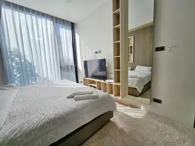 a bedroom with a bed and a large mirror at The Viva Patong Condo - 1Bdr - 35sqm Studio - Patong Hills in Patong Beach