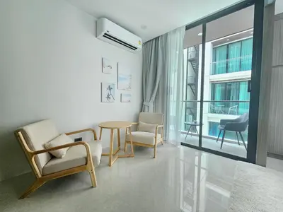 a living room with chairs and a table and a window at The Viva Patong Condo - 1Bdr - 35sqm Studio - Patong Hills in Patong Beach