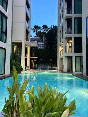 a swimming pool in the middle of two apartment buildings at The Viva Patong Condo - 1Bdr - 35sqm Studio - Patong Hills in Patong Beach