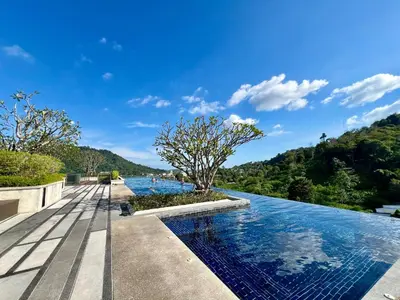 a infinity pool with a tree in the middle at 1BR Apartment with Rooftop Pool - The Base Height Phuket town in Ban Sam Kong