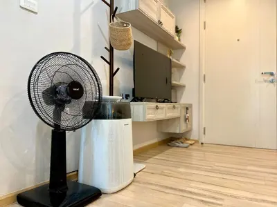 a fan sitting on the floor in a room at 1BR Apartment with Rooftop Pool - The Base Height Phuket town in Ban Sam Kong