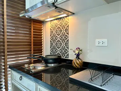 a kitchen with a stove and a pot on a counter at 1BR Apartment with Rooftop Pool - The Base Height Phuket town in Ban Sam Kong
