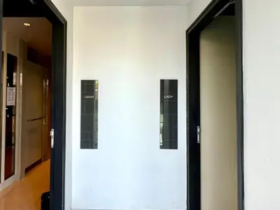 a hallway with two elevators in a building at 1BR Apartment with Rooftop Pool - The Base Height Phuket town in Ban Sam Kong