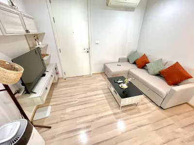 a living room with a couch and a tv at 1BR Apartment with Rooftop Pool - The Base Height Phuket town in Ban Sam Kong