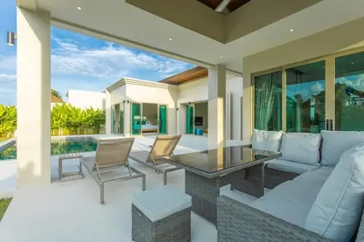 a patio with a couch and a table and chairs at Brand New Completed v124 in Chalong