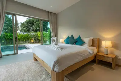 a bedroom with a bed and a large window at Brand New Completed v124 in Chalong