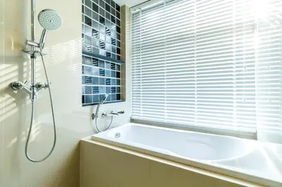a bathroom with a tub and a shower and a window at Deck Condo private apartment by Lofty in Patong Beach