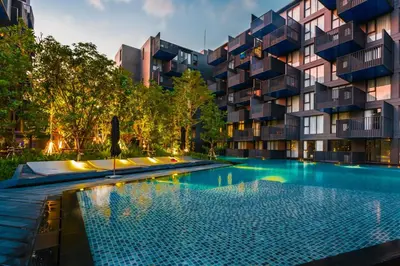 a swimming pool in front of a building at Deck Condo private apartment by Lofty in Patong Beach