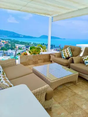a living room with couches and a table at Eagles Nest Patong in Patong Beach
