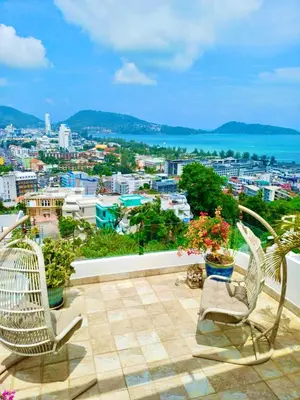 a balcony with chairs and a view of a city at Eagles Nest Patong in Patong Beach