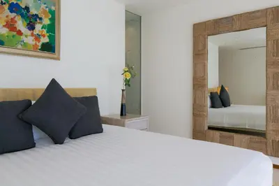 a bedroom with a bed and a mirror at The Heights Penthouse A5 3Bedrooms Seaview near Kata Beach in Kata Beach