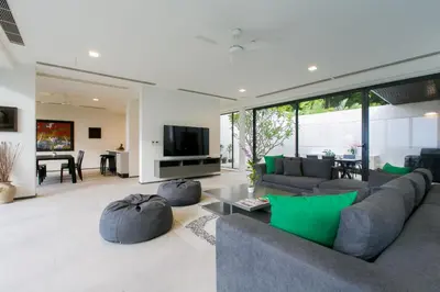 a living room with a gray couch and green pillows at The Heights Penthouse A5 3Bedrooms Seaview near Kata Beach in Kata Beach