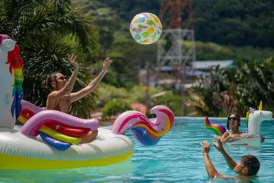 a group of people playing with a ball in a swimming pool at Luxury Pool Villa in Nai Harn - Villa Solana in Rawai Beach