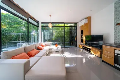 a living room with a white couch and a tv at BangT-ao 3-bedroom modern minimalist luxury style private pool holiday villa gym quiet community in Bang Tao Beach