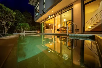 an indoor swimming pool in a house at night at BangT-ao 3-bedroom modern minimalist luxury style private pool holiday villa gym quiet community in Bang Tao Beach