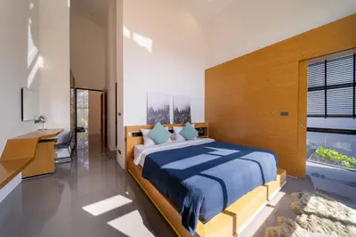 a bedroom with a bed and a desk and a window at BangT-ao 3-bedroom modern minimalist luxury style private pool holiday villa gym quiet community in Bang Tao Beach