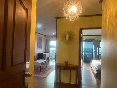 a hallway with a room with a bed and a chandelier at Patong Tower Dream Sea View Apartment in Patong Beach