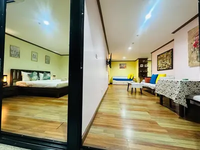 a bedroom with a bed and a living room at Patong Tower Dream Sea View Apartment in Patong Beach