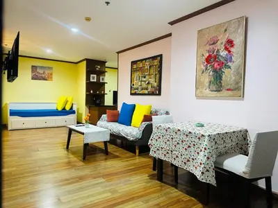 a living room with a couch and a table at Patong Tower Dream Sea View Apartment in Patong Beach