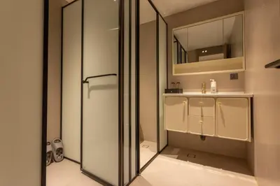 a bathroom with a shower and a sink and a mirror at YUSU Hotel \u7fbd\u5bbf\u9152\u5e97 in Phuket Town