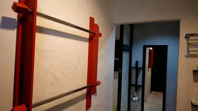 a sliding glass door with red handles in a room at By the Sea Apartment Hotel in Krabi town