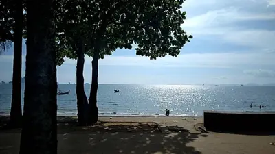 a beach with trees and a body of water at By the Sea Apartment Hotel in Krabi town