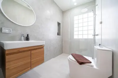 a bathroom with a sink and a toilet and a mirror at Brand New 4BR Balinese Style Pool Villa Kaia just 5 min drive from NaiHarn Beach in Rawai Beach
