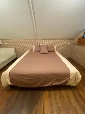 a bedroom with a large bed with two pillows at Baibon2 Homestay Thalang Phuket in Thalang