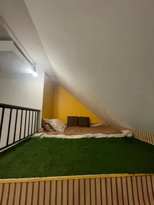 a bed in the middle of a room with grass at Baibon2 Homestay Thalang Phuket in Thalang
