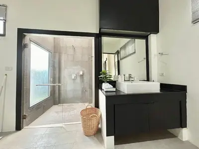 a bathroom with a shower and a sink and a mirror at Garden 2 bedrooms pool villa in Laguna Phuket