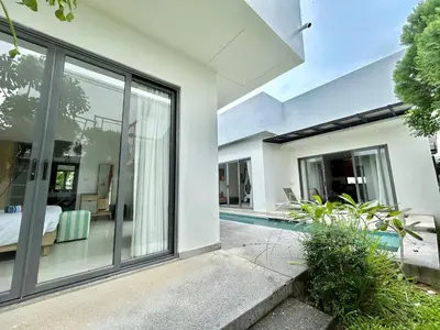 an external view of a house with a swimming pool at Garden 2 bedrooms pool villa in Laguna Phuket