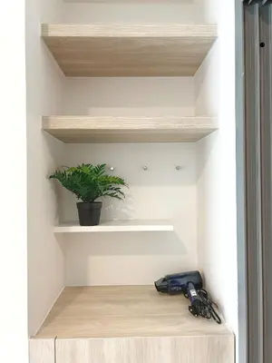 a potted plant sitting on a shelf in a room at PHYLL Condo Private Beach Vibes at Central Phuket 1 BR Unique Garden View in Ban Rangeng