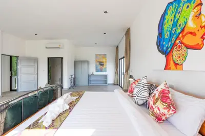 a living room with a large white couch in a room at Sirinary Villa Phuket in Ban Ao Makham