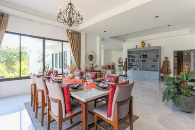 a dining room with a table and chairs at Sirinary Villa Phuket in Ban Ao Makham