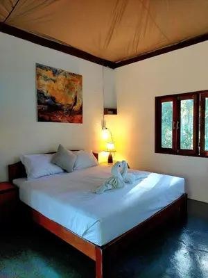 a bedroom with a large bed with a towel on it at House On The Bay2, Koh Yao in Ko Yao Noi